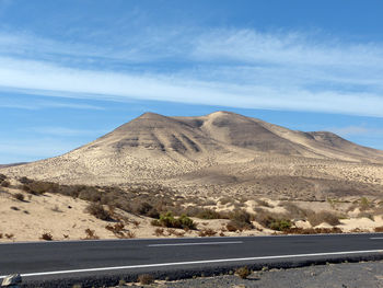 Scenic view of mountains against cloudy sky