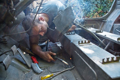 Man working on barbecue grill