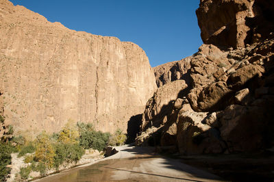 Road amidst rocks against clear sky