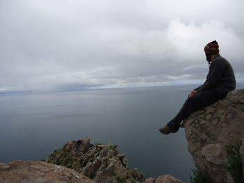 Man looking at sea against sky