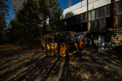 Abandoned vehicle on land against sky