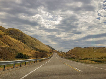 Empty road along countryside landscape