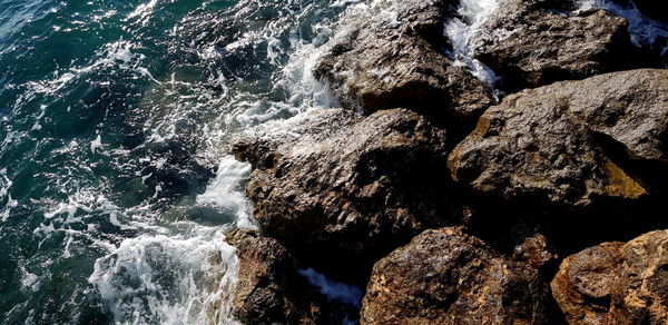 High angle view of rocks at sea shore