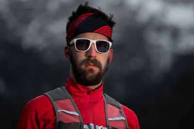 Portrait of young man wearing sunglasses standing outdoors