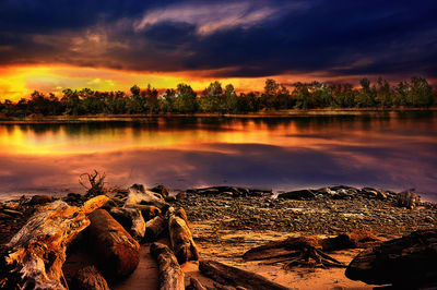 Scenic view of lake against orange sky