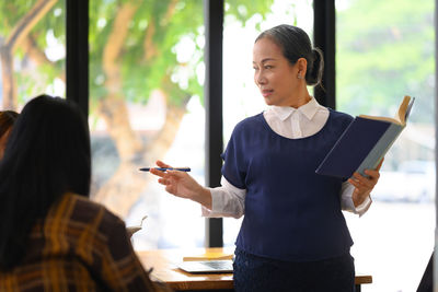 Side view of business colleagues working at office