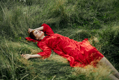 Side view of girl lying down on land