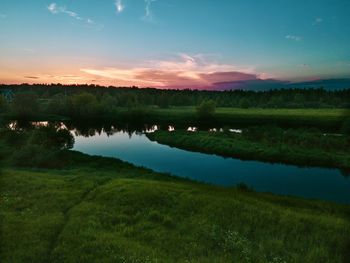 Scenic view of lake against sky during sunset