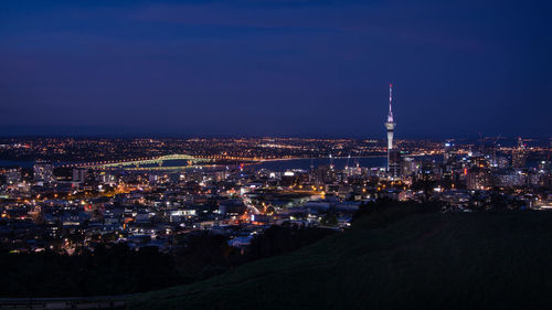 Illuminated city against sky at night