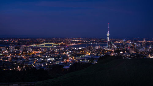 Illuminated city against sky at night