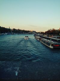 Boats in river against clear sky