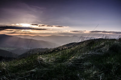 Scenic view of mountains against sky at sunset