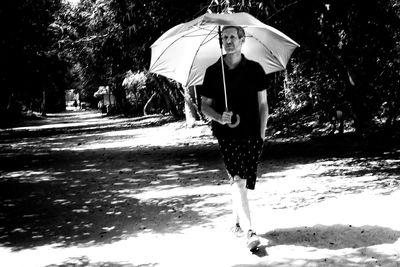 Man walking on wet umbrella