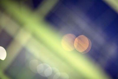 Defocused image of illuminated tree against sky