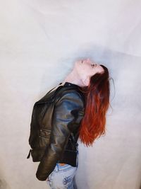 Young woman with hands standing against white background