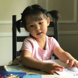 Portrait of cute girl on table