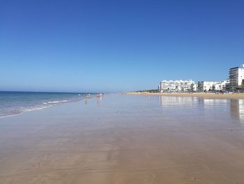 Scenic view of beach against clear sky