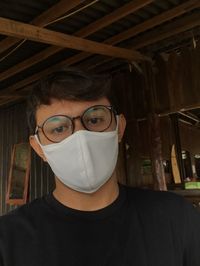 Close-up portrait of a young man with mask