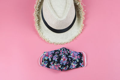 High angle view of hat over pink background