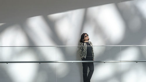 Woman standing against wall