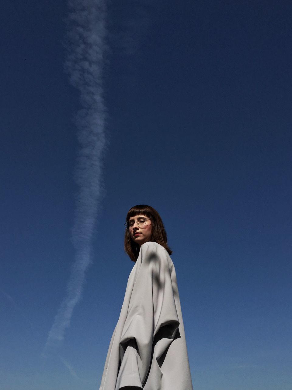 blue, sky, one person, low angle view, nature, adult, copy space, young adult, white, day, portrait, standing, clothing, women, cloud, looking, leisure activity, looking up, waist up, lifestyles, outdoors, happiness, smiling, clear sky, person, emotion, human face