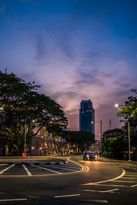 View of city street against sky at night