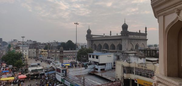 High angle view of buildings against cloudy sky