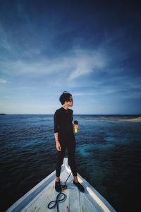 Full length of man standing on sea against sky