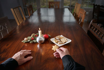 High angle view of hand holding ice cream on table