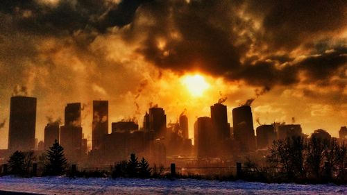 Scenic view of city against sky during sunset