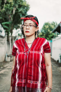 Portrait of beautiful young woman standing outdoors