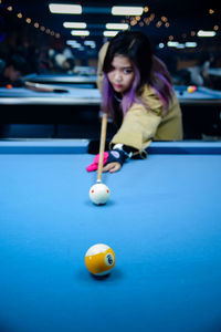 Portrait of woman playing pool