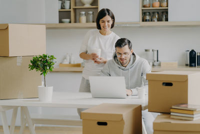 Couple with cardboard boxes at new home