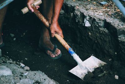 Low section of man working at shore