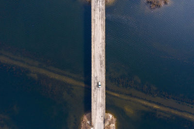 Aerial view of car on bridge over lake