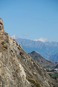 Scenic view of mountain range against blue sky