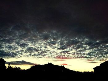 Scenic view of silhouette landscape against dramatic sky