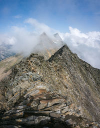 Low angle view of rocky mountain against sky