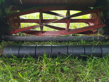 Close-up of rusty metal railing on field