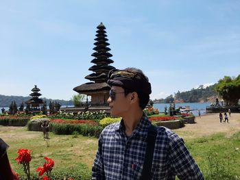 Portrait of beautiful young woman against sky