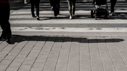 Low section of people walking on footpath