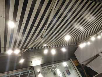 Low angle view of illuminated lights hanging from ceiling