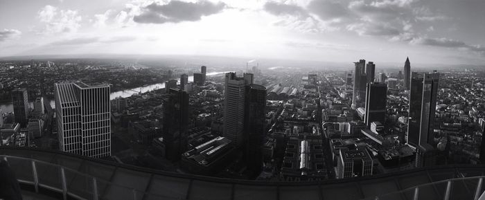 Aerial view of buildings in city against sky