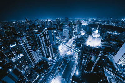 High angle view of illuminated buildings in city at night