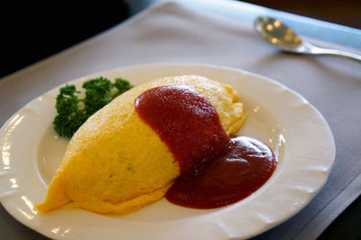 High angle close-up of omurice served in plate