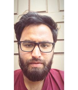 Portrait of young man wearing eyeglasses at home