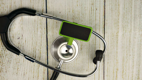 Stethoscope with blank board on wooden table