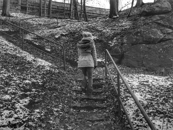 Full length of woman standing by railing