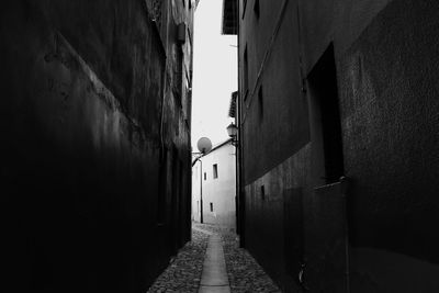 Narrow alley amidst buildings in city