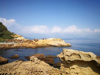 Scenic view of sea against blue sky